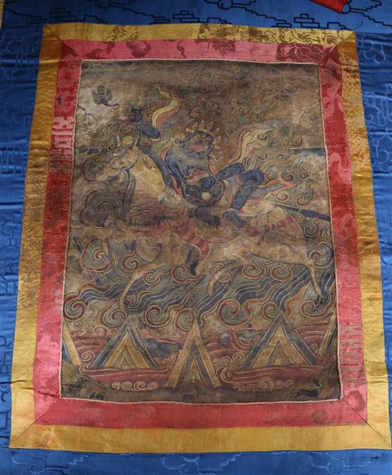 A Tibetan thangka, the central panel 15 x 11in.